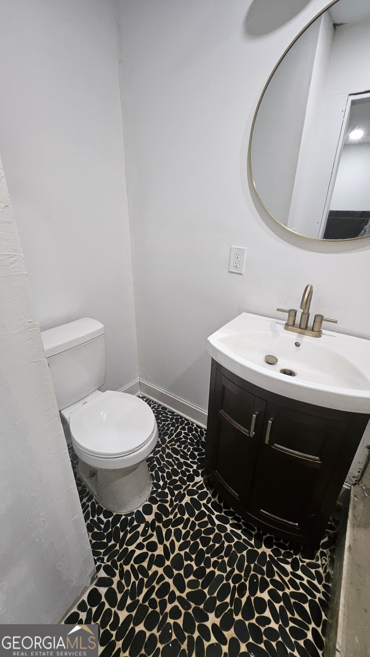 4360 Stonewall Tell Road College Park, GA 30349 - Photo 21 of 49 a bathroom with a sink toilet and mirror