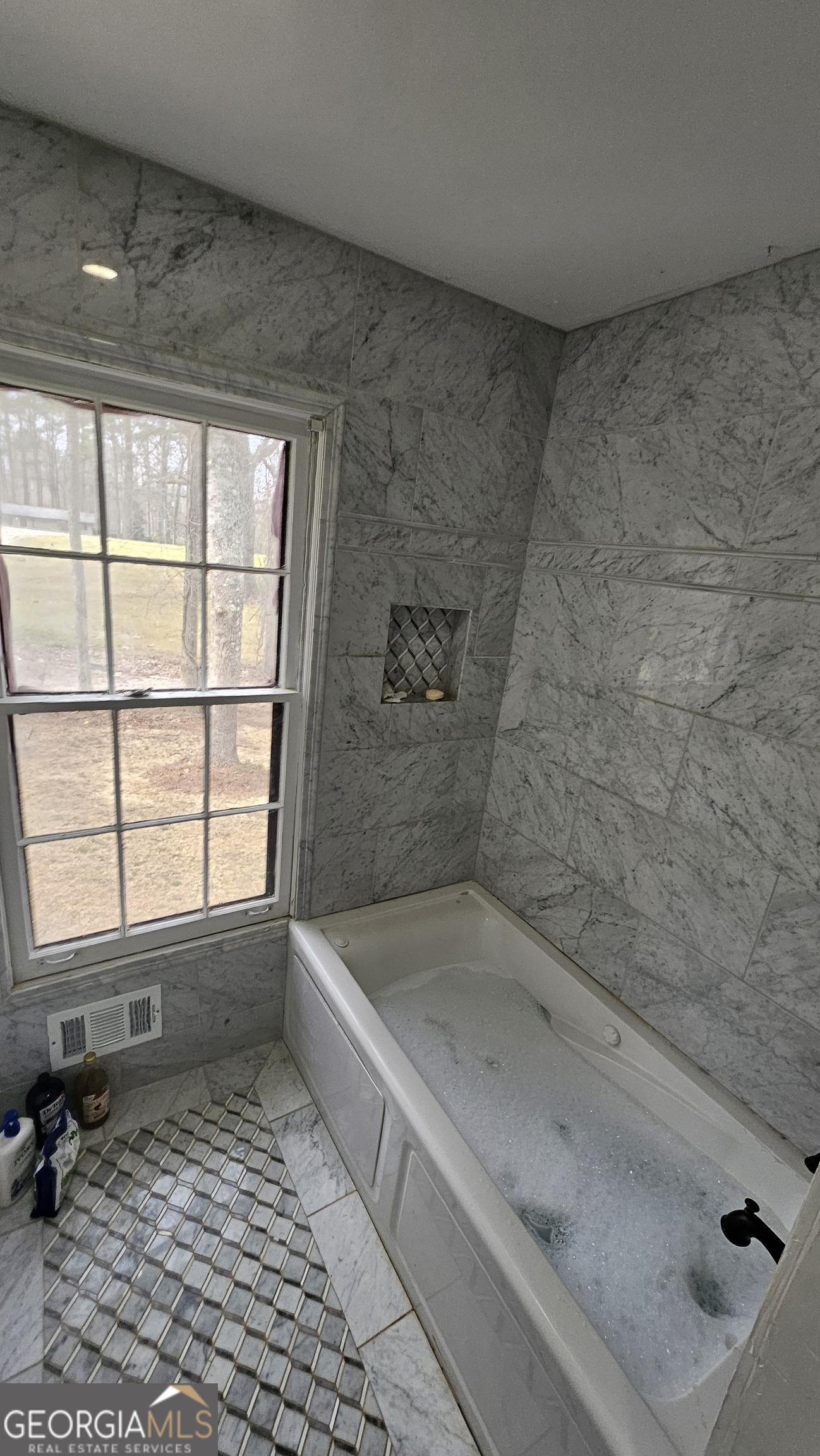 4360 Stonewall Tell Road College Park, GA 30349 - Photo 25 of 49 a bathroom with a bathtub and next to a window