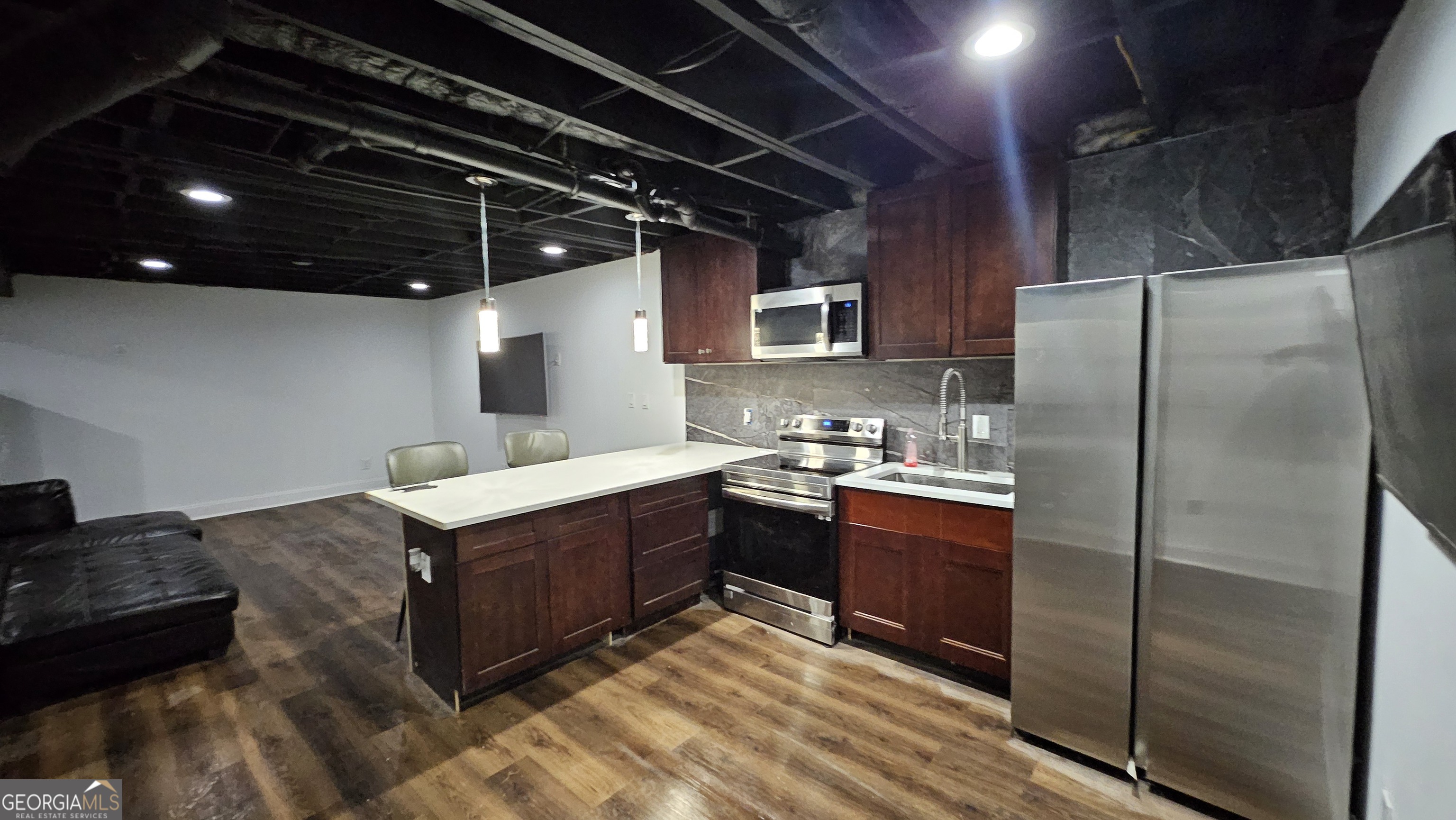 4360 Stonewall Tell Road College Park, GA 30349 - Photo 32 of 49 a kitchen with stainless steel appliances granite countertop a sink stove and refrigerator