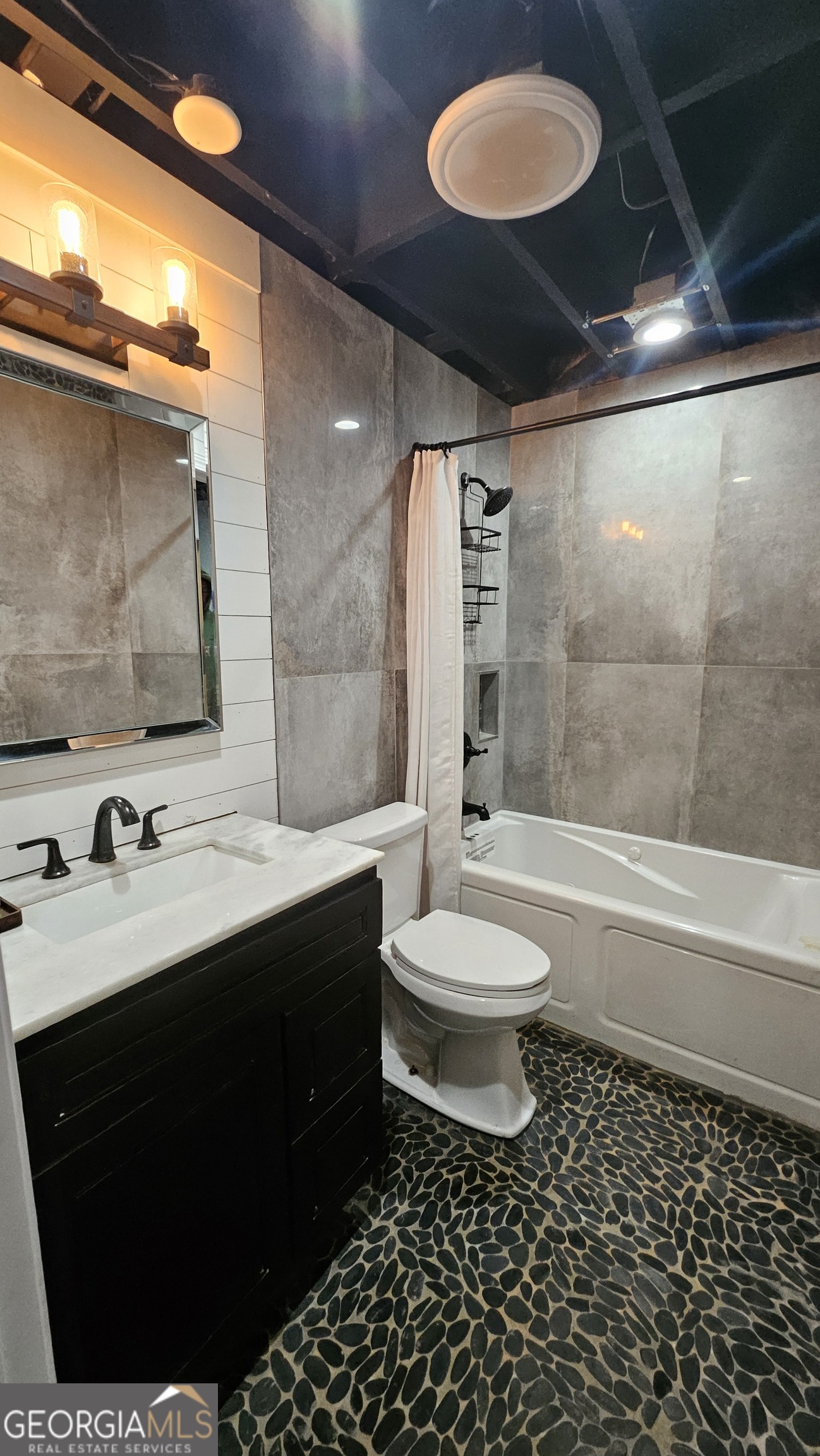 4360 Stonewall Tell Road College Park, GA 30349 - Photo 38 of 49 a bathroom with a double vanity sink toilet and shower