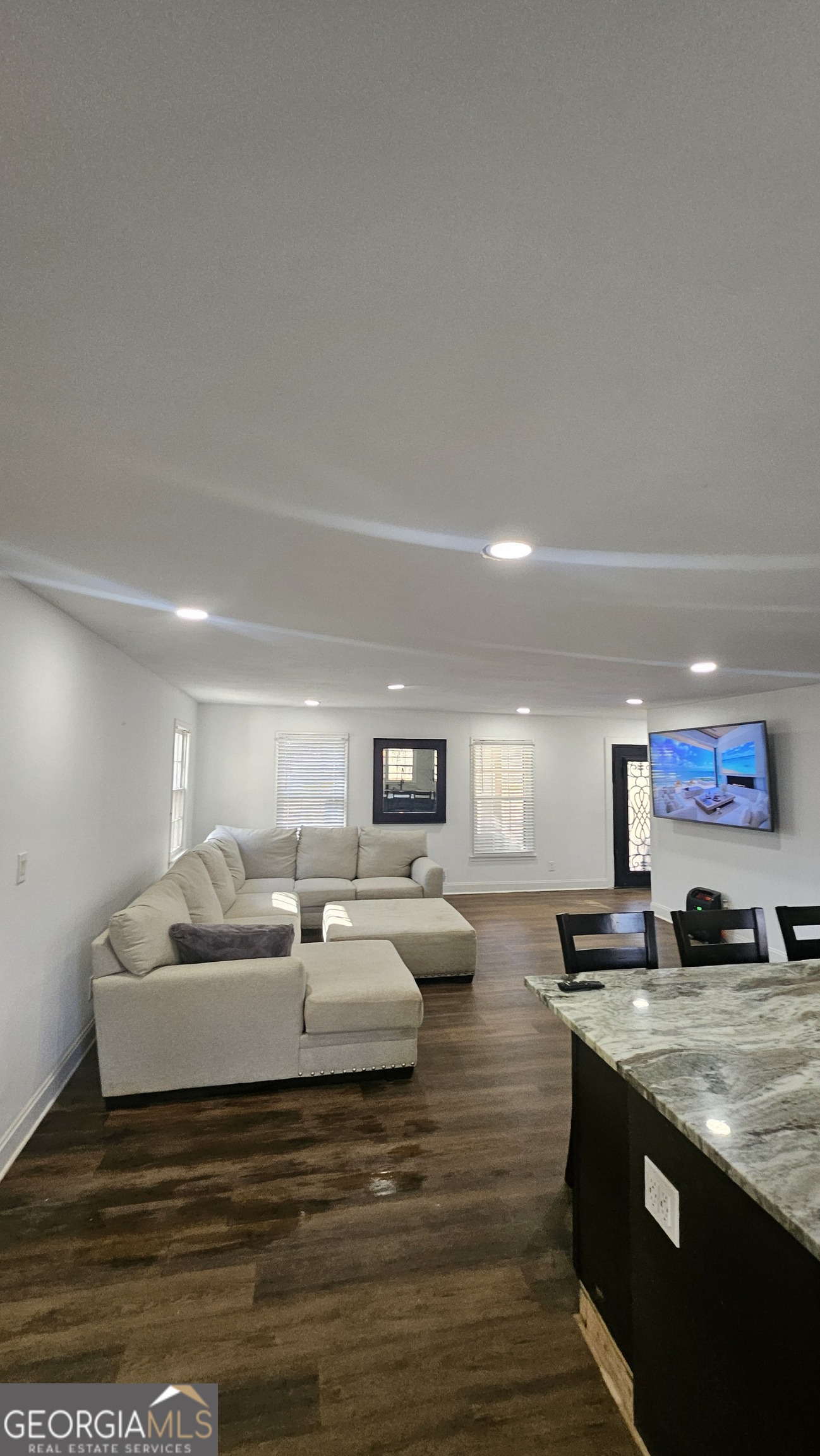 4360 Stonewall Tell Road College Park, GA 30349 - Photo 5 of 49 a large bedroom with a bed and a view of kitchen