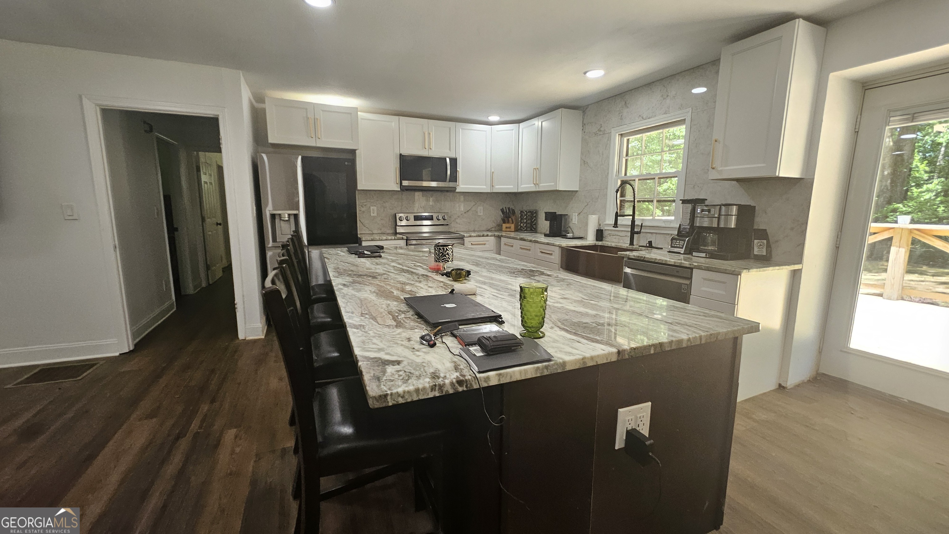 4360 Stonewall Tell Road College Park, GA 30349 - Photo 9 of 49 a large kitchen with granite countertop lots of counter top space and stainless steel appliances