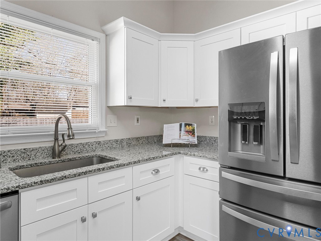 12206 Timber Trail Drive Midlothian, VA 23112 - Photo 18 of 40 a kitchen with granite countertop stainless steel appliances white cabinets and a window