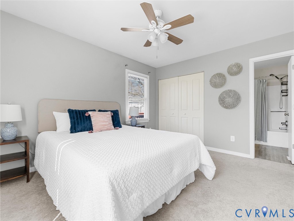 12206 Timber Trail Drive Midlothian, VA 23112 - Photo 22 of 40 a bedroom with a large bed and a chandelier