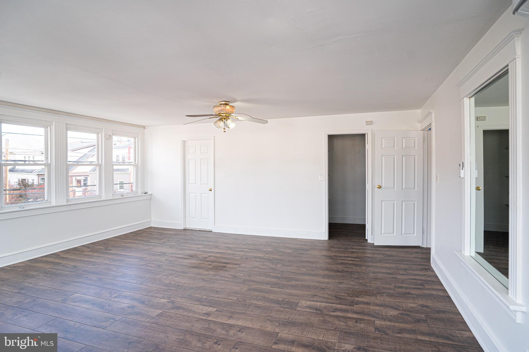 2540 East County Line Road Ardmore, PA 19003 - Photo 11 of 22 a view of an empty room with wooden floor and a window