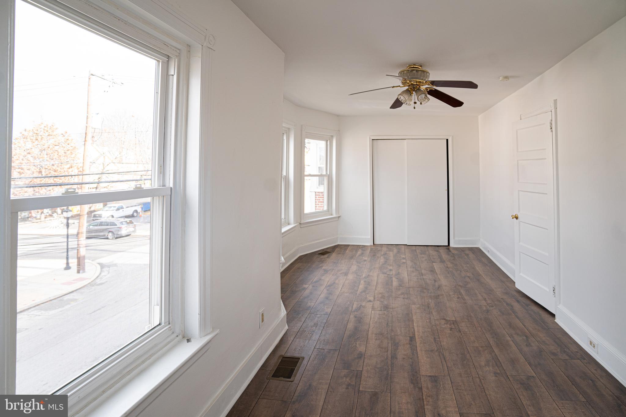 2540 East County Line Road Ardmore, PA 19003 - Photo 14 of 22 a view of empty room with wooden floor and fan
