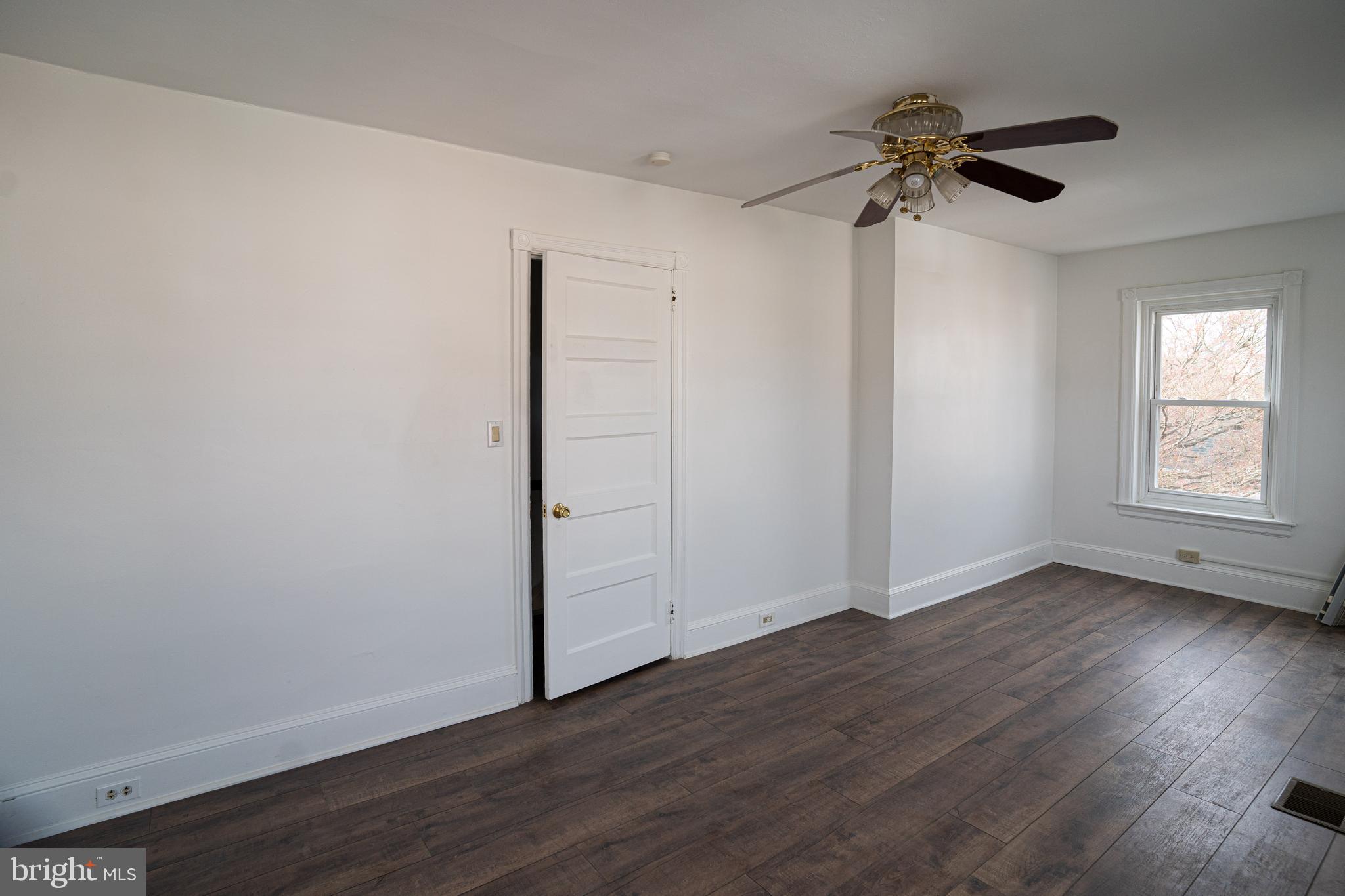 2540 East County Line Road Ardmore, PA 19003 - Photo 15 of 22 a view of an empty room with wooden floor and a window