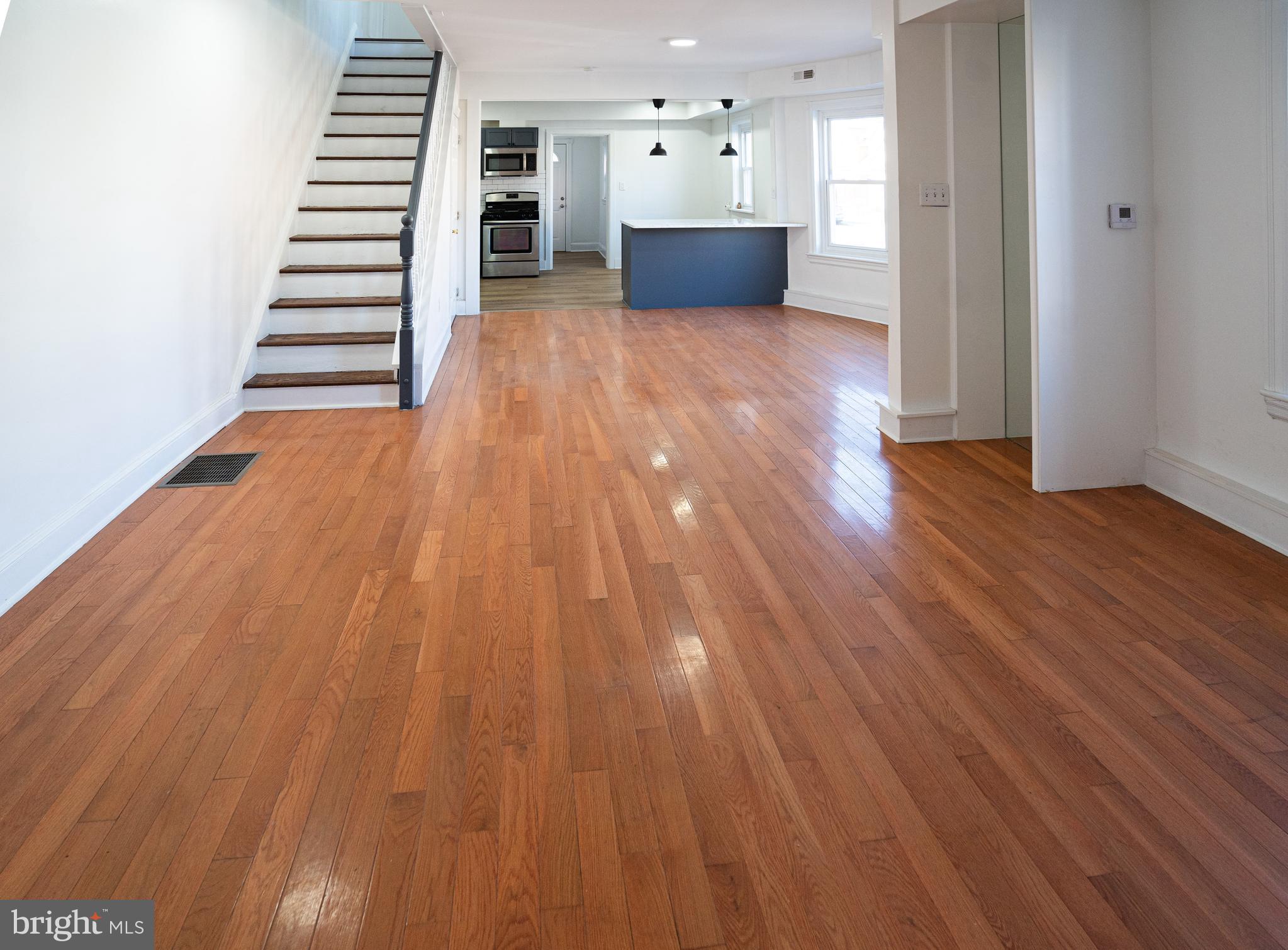 2540 East County Line Road Ardmore, PA 19003 - Photo 4 of 22 a view of a room with wooden floor and stairs