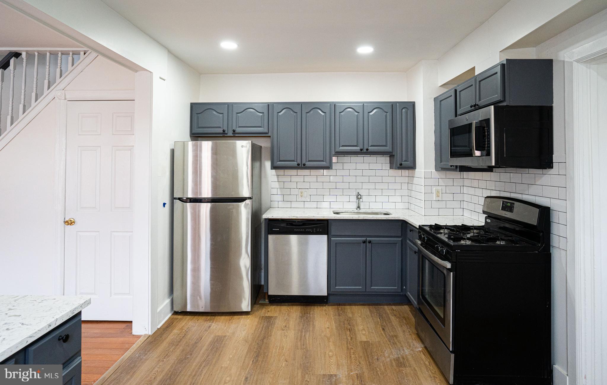 2540 East County Line Road Ardmore, PA 19003 - Photo 7 of 22 a kitchen with a refrigerator stove and microwave