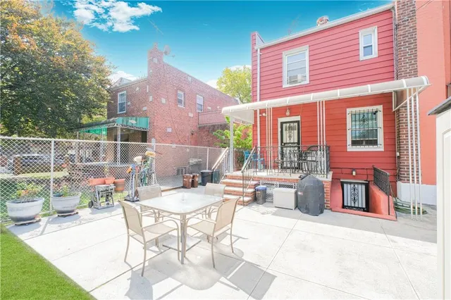 a view of a patio with couches table and chairs and potted plants
