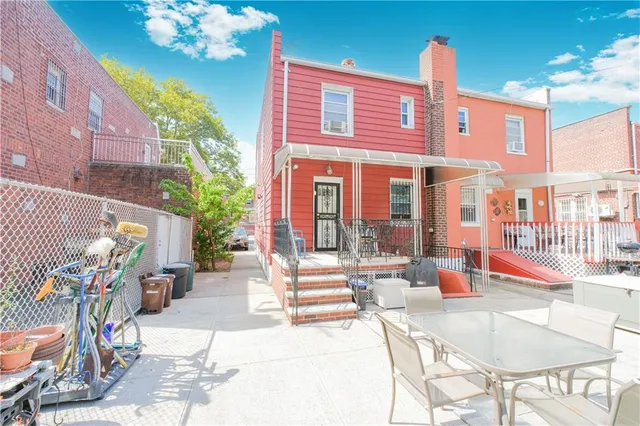 a front view of a building with table and chairs