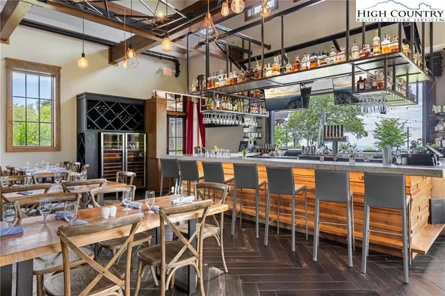 an outdoor space with the couches and dining table with the view of city