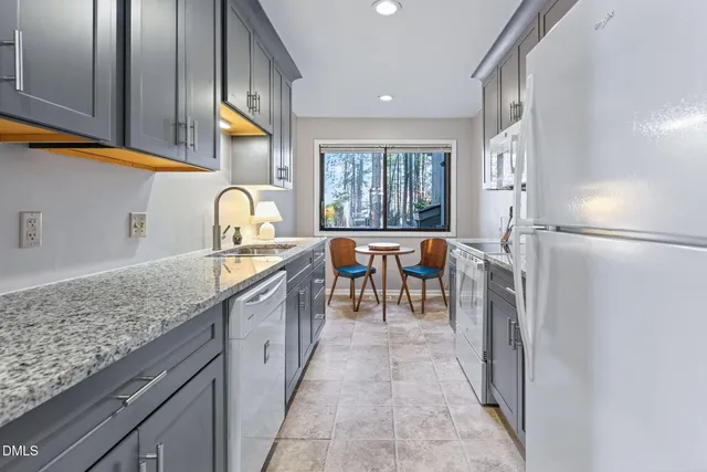 a kitchen with stainless steel appliances granite countertop a sink stove and cabinets