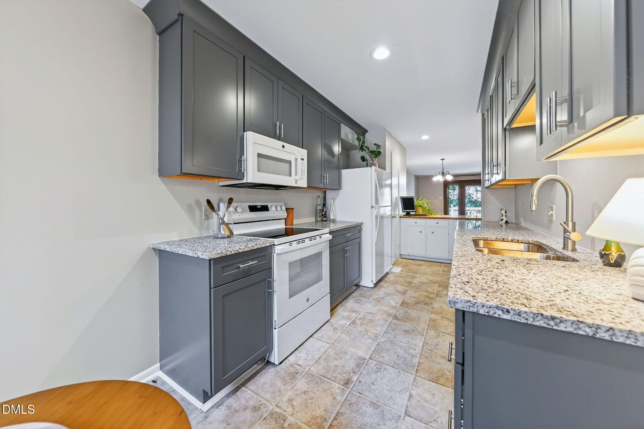 216 Ridge Trail Chapel Hill, NC 27516 - Photo 15 of 30 a kitchen with stainless steel appliances granite countertop a sink stove and cabinets