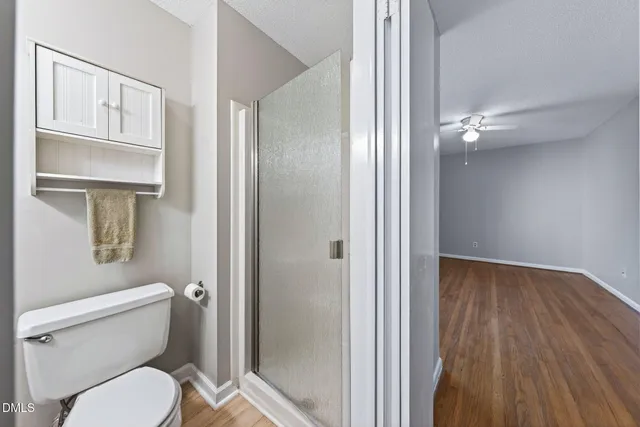 a view of an empty room with wooden floor