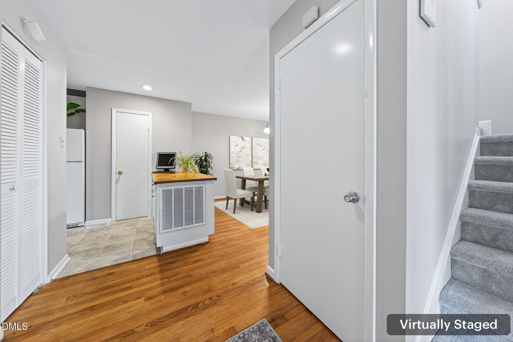 216 Ridge Trail Chapel Hill, NC 27516 - Photo 5 of 30 a view of a hallway with wooden floor windows and a livingroom