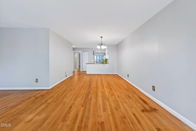 a view of a room with wooden floor and cabinet