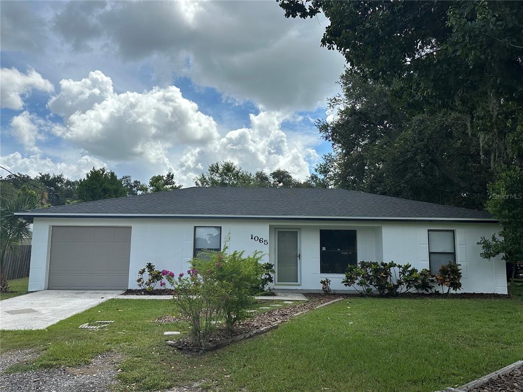 1065 Jordan Road Lakeland, FL 33811 - Photo 1 of 1 a front view of a house with garden and porch