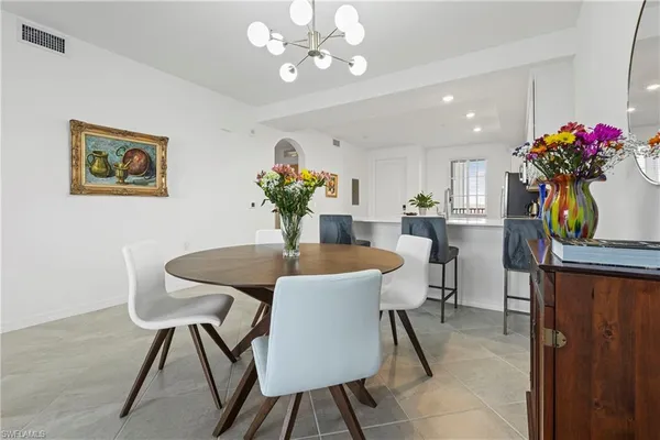 a view of a dining room with furniture and chandelier
