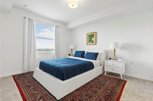 a bedroom with bed and painting on the wall