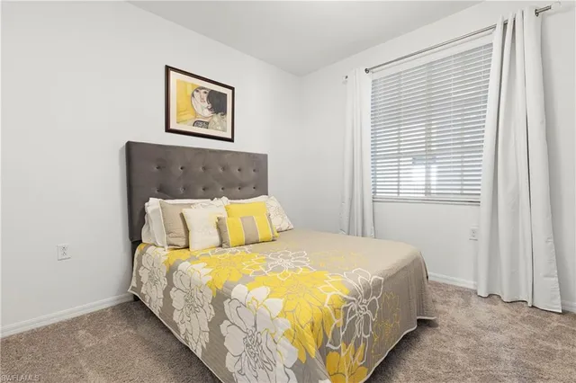 a bedroom with a bed and wall painting