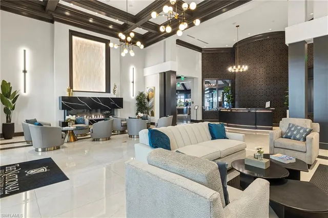 a room with lots of tables a large window and chairs