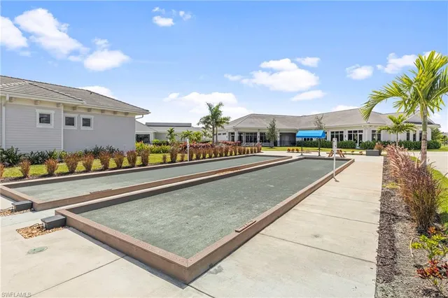 a view of a big building with big yard and large trees