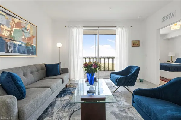 a living room with furniture and a large window