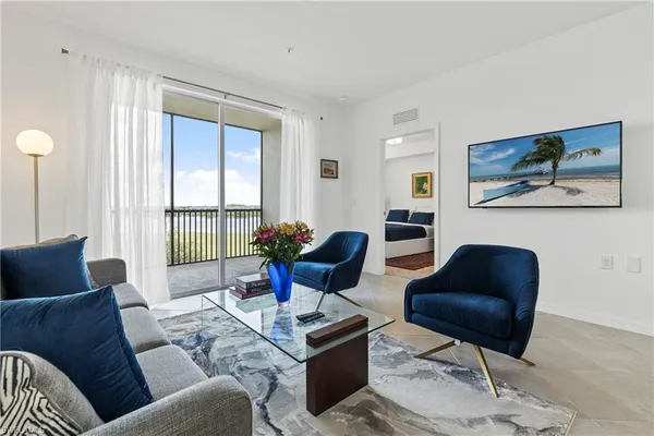 a living room with furniture and a chandelier