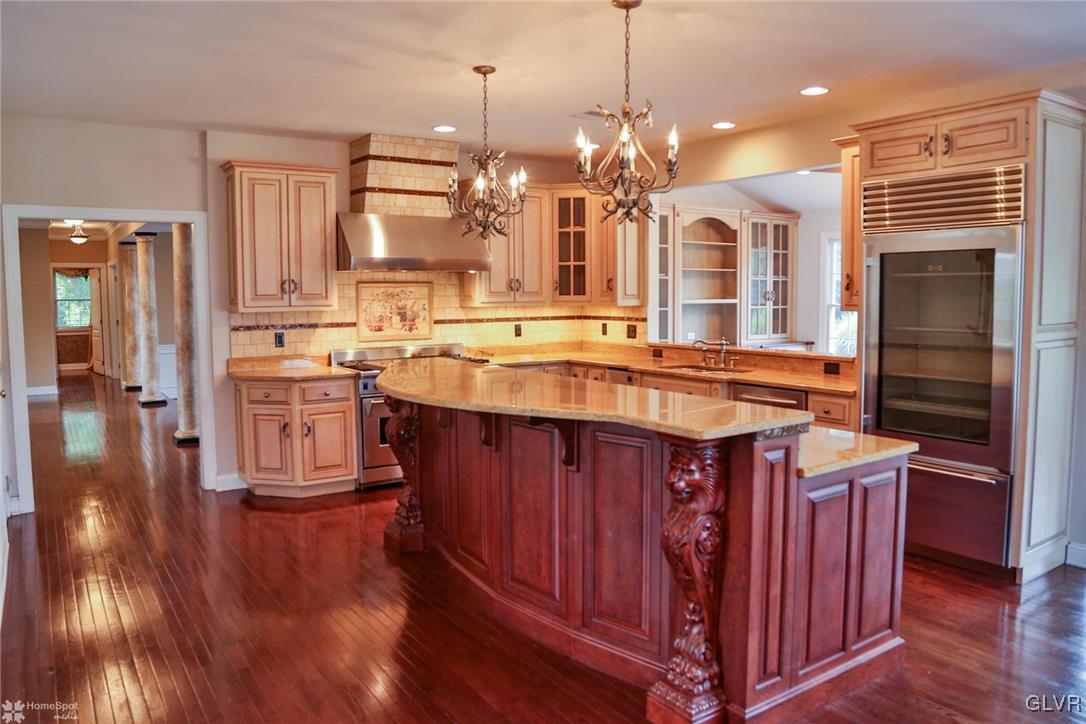 577 Rockbridge Road Nazareth, PA 18064 - Photo 22 of 50 a kitchen with stainless steel appliances granite countertop a stove a sink dishwasher and a refrigerator with wooden floor