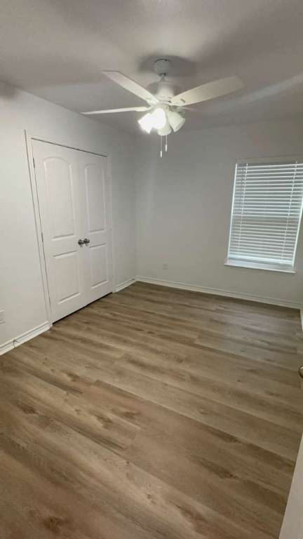 14205 Prairie Sod Lane Elgin, TX 78621 - Photo 14 of 24 a view of an empty room with wooden floor and a window
