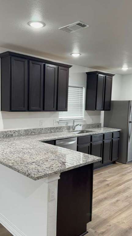 14205 Prairie Sod Lane Elgin, TX 78621 - Photo 5 of 24 a kitchen with a sink and cabinets