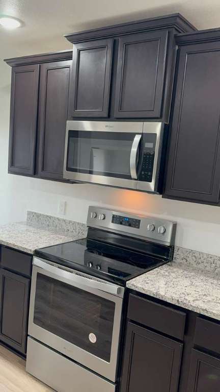 14205 Prairie Sod Lane Elgin, TX 78621 - Photo 6 of 24 a stove top oven sitting inside of a kitchen
