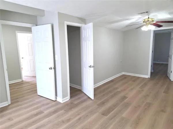 a view of a room with wooden floor