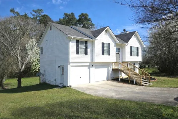 a front view of a house with a yard