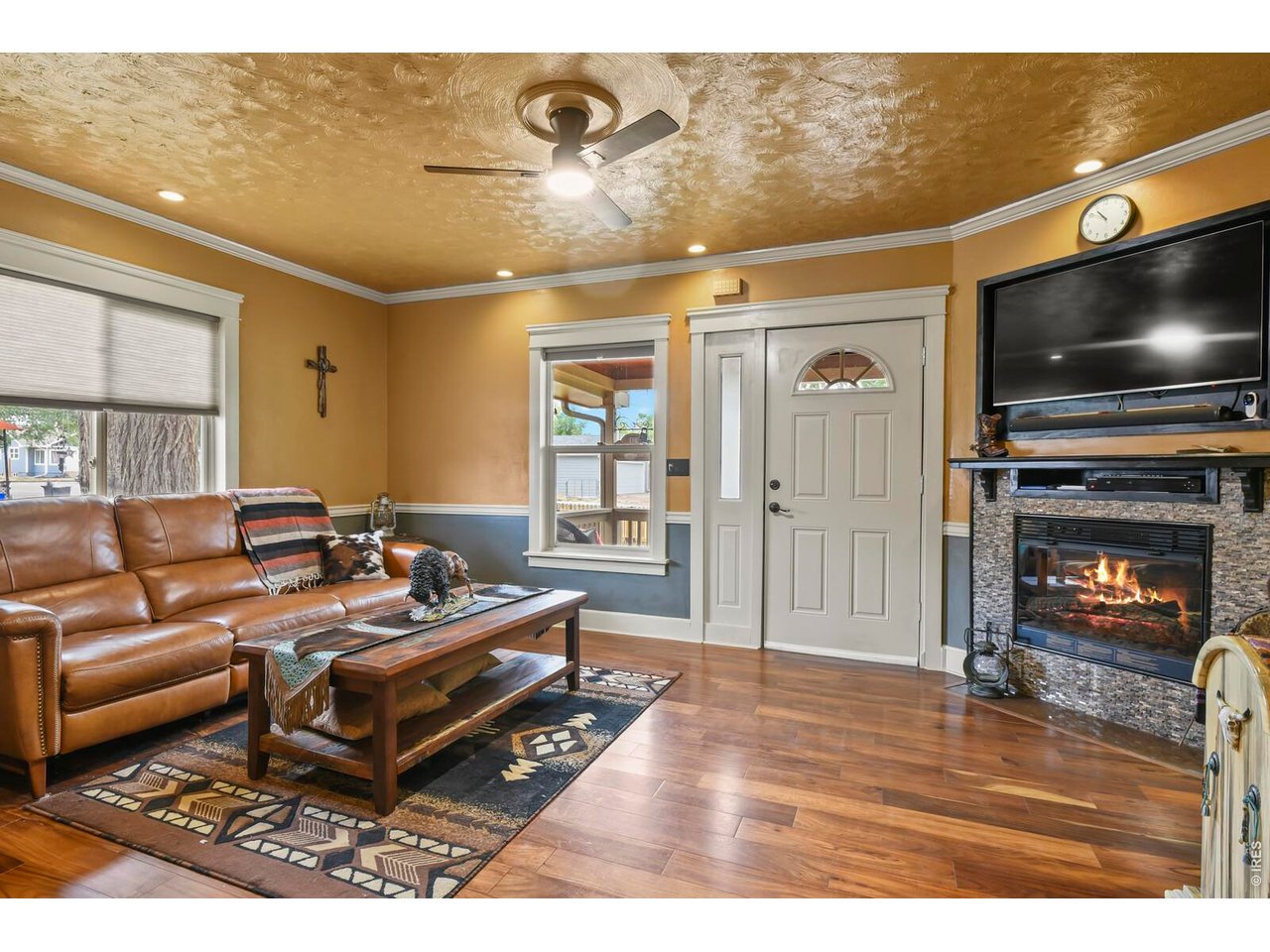 417 2nd Street Fort Lupton, CO 80621 - Photo 3 of 24 a living room with furniture and a flat screen tv
