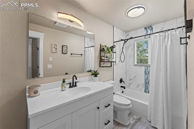 a bathroom with a double vanity sink toilet and shower