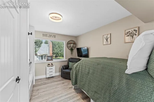 a bedroom with a bed and a large window