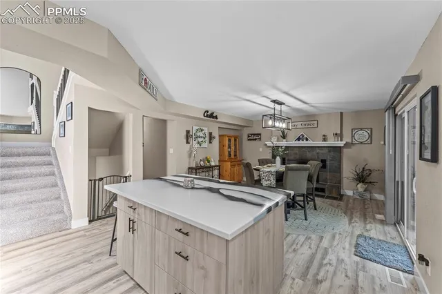 a view of a center kitchen island wooden floor and living room