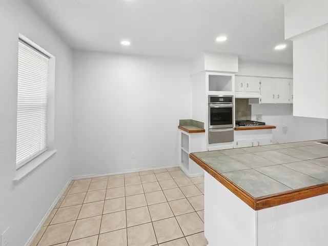 a view of a kitchen cabinets and a counter place