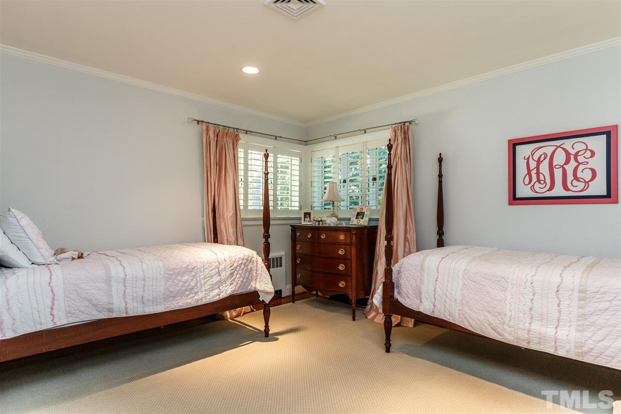 2509 Wake Drive Raleigh, NC 27608 - Photo 14 of 25 a bedroom with a bed and a window