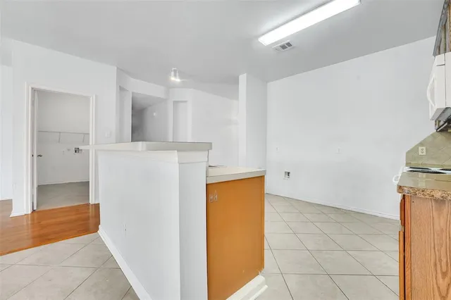 a kitchen with stainless steel appliances granite countertop a stove a sink dishwasher and a refrigerator