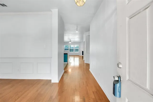 a view of a hallway with wooden floor
