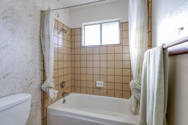 a bathroom with a bathtub and shower