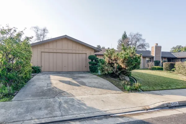 a view of backyard of house with garage