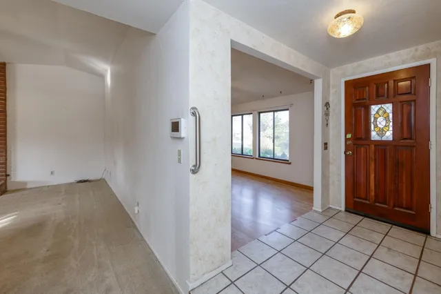 a view of a hallway with wooden floor and windows