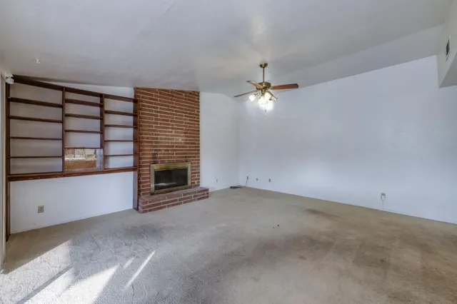 a view of a livingroom with a fireplace and chandelier