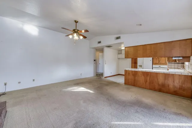 a view of a kitchen with a sink and chandelier