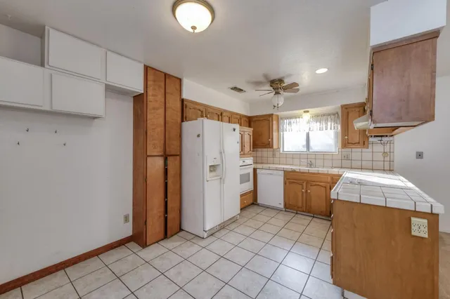 a kitchen with a refrigerator a sink and dishwasher