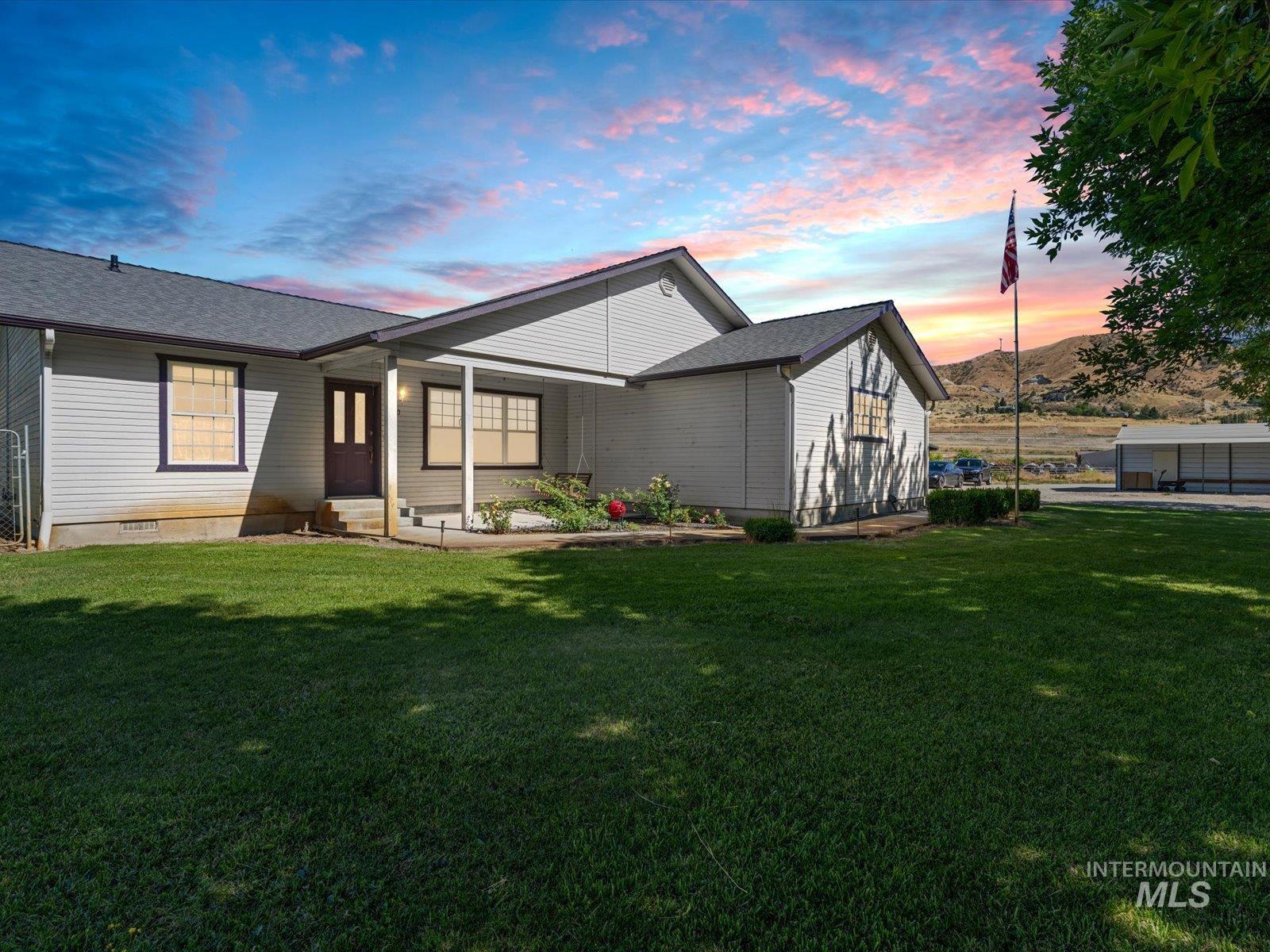 3540 Wills Road Emmett, ID 83617 - Photo 1 of 36 Exterior featuring light-colored siding, dark trim windows, and a covered porch entry